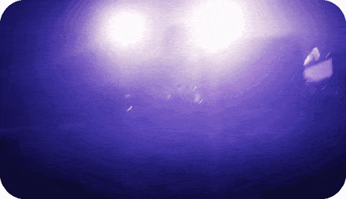 a purple background with a few white lights in it