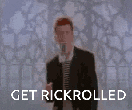 a man in a suit is singing into a microphone and the words get rickrolled are visible behind him .