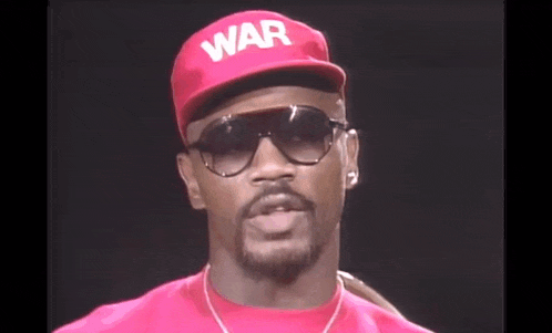 a man wearing a red hat and sunglasses with the word war on it