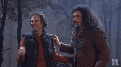 a man and a woman are kissing in the woods at night .