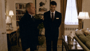 a man in a black suit has a name tag on his chest that says ' james ' on it