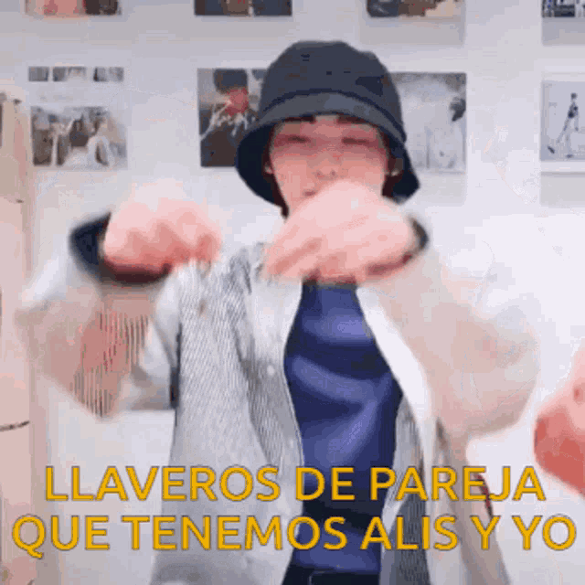 a person wearing a hat is dancing with the words llaveros de pareja que tenemos alis y yo below them