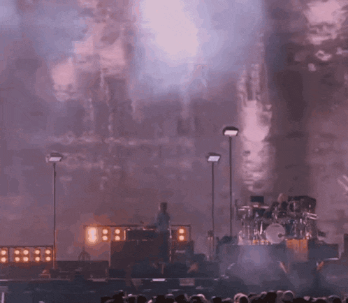 a group of people are watching a band on stage