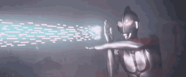 a man in a silver superhero costume is holding a lightning bolt in his hand