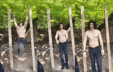 a shirtless man is doing pull ups on a bar