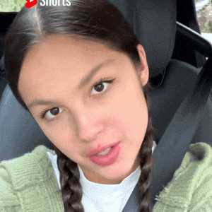 a close up of a woman 's face in a car with the word shorts on the bottom right