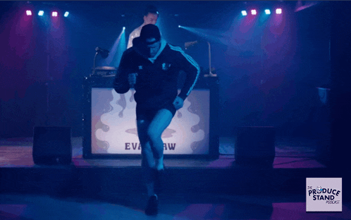 a woman dancing on a stage in front of a dj booth that says vr show