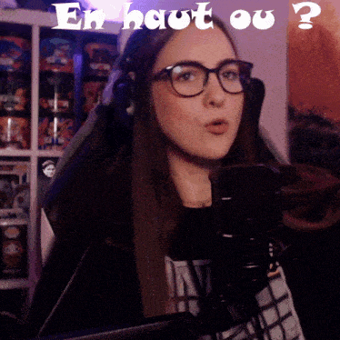 a woman wearing glasses and headphones stands in front of a microphone with the words " en haut ou " above her