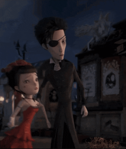 a man with an eye patch and a woman in a red dress standing next to each other