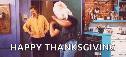two men are standing in a kitchen with the words `` happy thanksgiving '' written in the corner .