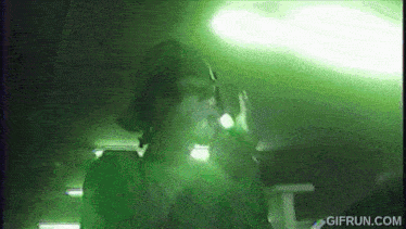 a gif from gifrun.com shows a man in a green light