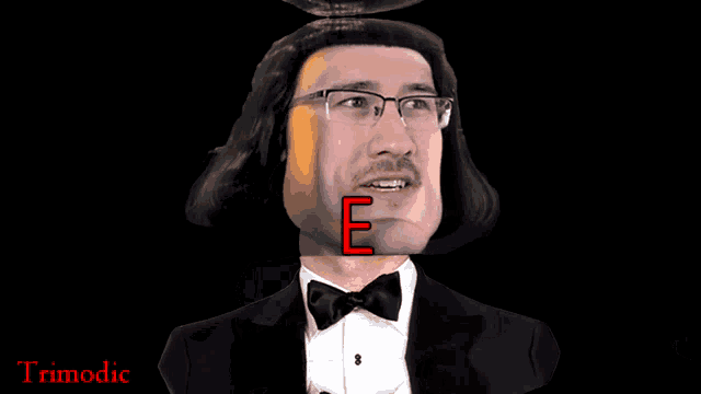 a man in a tuxedo with the letter e in the background