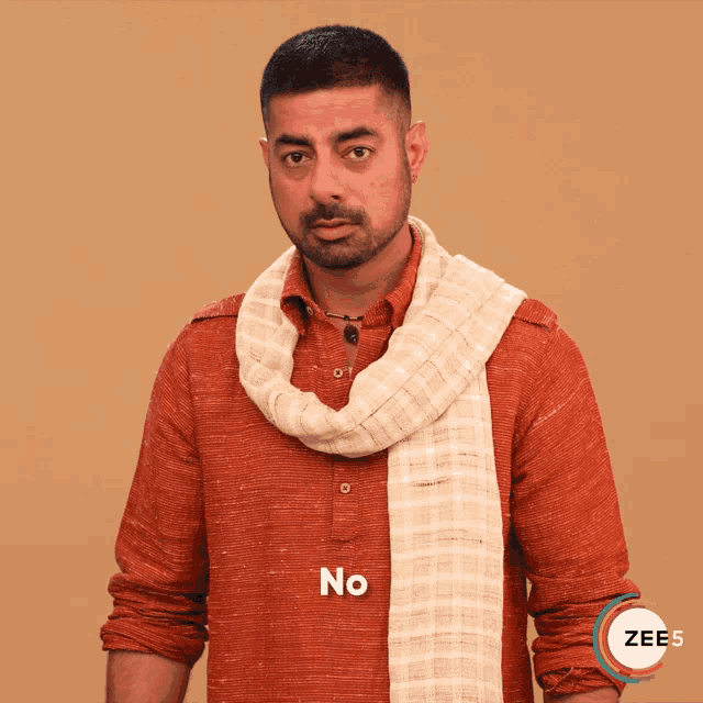 a man with a scarf around his neck has the word no written above him