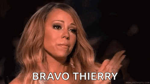 a woman is crying and applauding with the words `` bravo thierry '' written on her face .