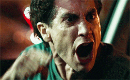 a close up of a man screaming with his mouth wide open