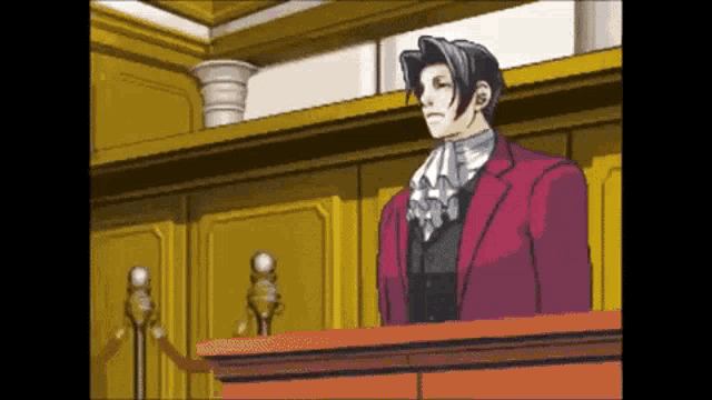 a man in a red suit stands behind a podium