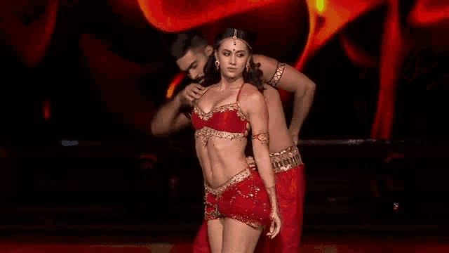 a man and woman are dancing on a stage .
