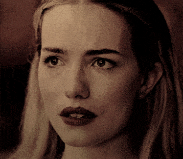 a close up of a woman 's face with dark lips