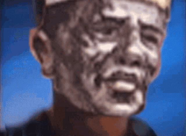 a blurry picture of a man 's face with a crown on his head