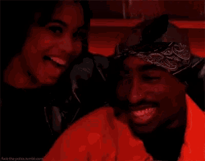 a man and a woman are smiling for a picture .