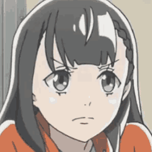 a close up of a girl 's face with a serious expression .