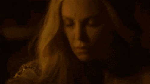 a close up of a woman 's face with her eyes closed and a tiara on her head .