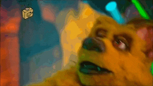 a close up of a cartoon character 's face with a cube that says ' c ' on it