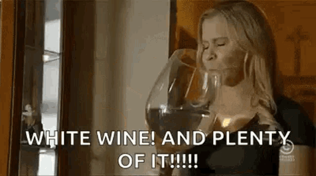 a woman is drinking a glass of white wine and saying `` white wine and plenty of it ! ''