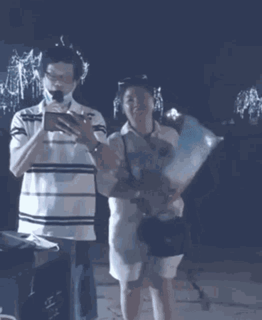 a man is holding a microphone while a woman is holding cotton candy .