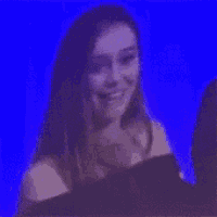 a woman is standing in front of a blue background .