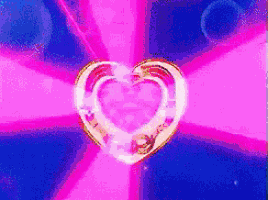 a pink and blue background with a heart shaped object in the middle
