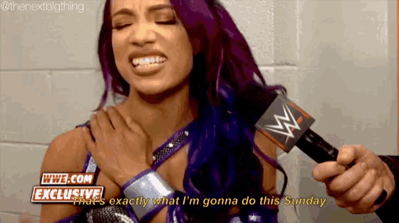 a woman with purple hair is talking into a microphone while wearing a wrestling outfit .