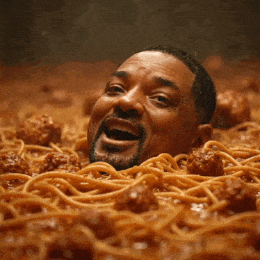 a man is surrounded by spaghetti and meatballs