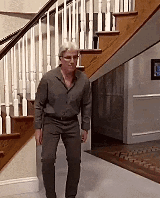 a man is walking down a set of stairs .