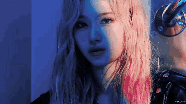 a close up of a woman with pink and blue hair