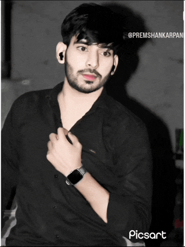 a man wearing a black shirt and a watch has a picture taken by picsart