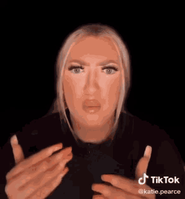 a woman is making a funny face with her mouth open in a tik tok video .