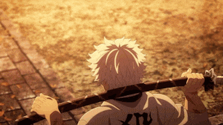 a man holding a sword with the letter x on the back of his shirt