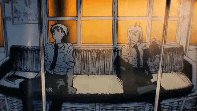 a man and a woman are sitting on a couch in front of a window .