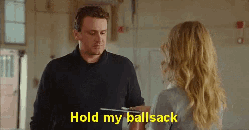 a man and a woman are talking and the woman is holding a clipboard and the man is saying hold my ballsack .