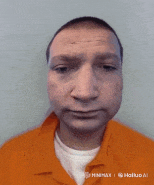 a man in an orange prison uniform has a white t-shirt underneath