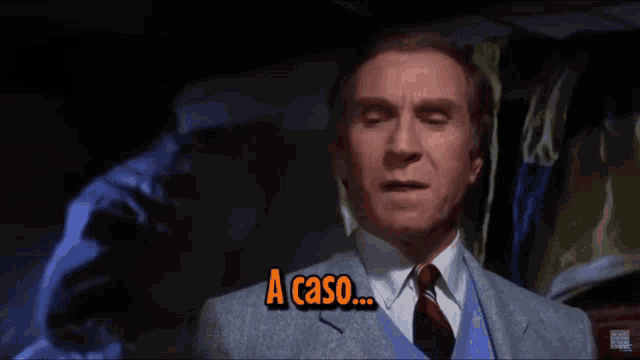 a man in a suit and tie says " a caso ... "