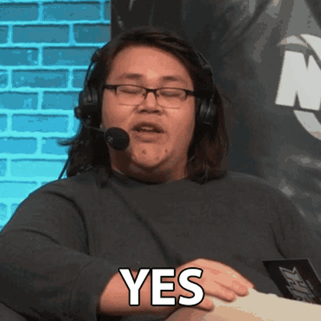 a man with glasses and headphones says yes