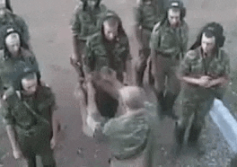 a group of soldiers are standing next to each other on a road .