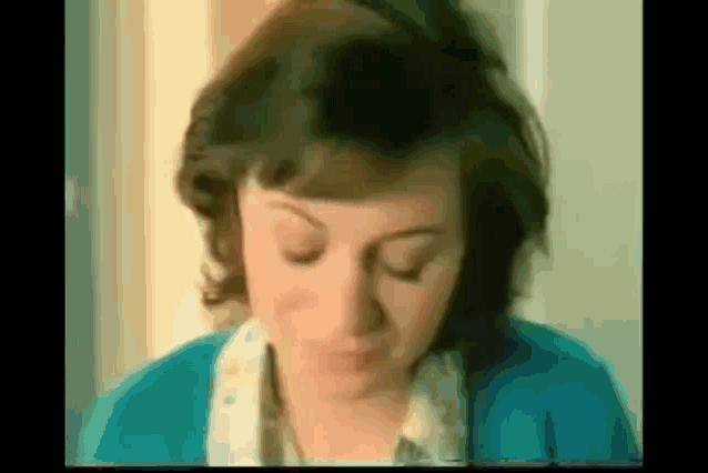 a close up of a woman 's face with her eyes closed .