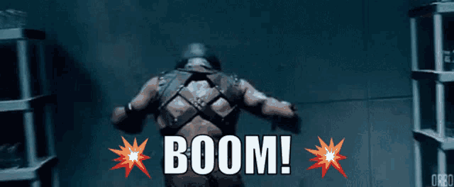 a man is standing in a dark room with the words boom written on the bottom