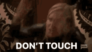 a woman is screaming with the words `` do n't touch '' behind her .