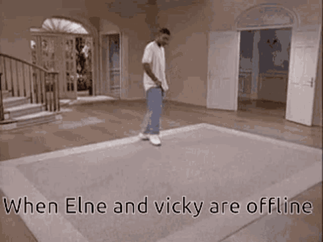 a man is standing on a rug in a living room with the words `` when elne and vicky are offline '' above him .