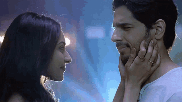 a man and a woman are looking at each other