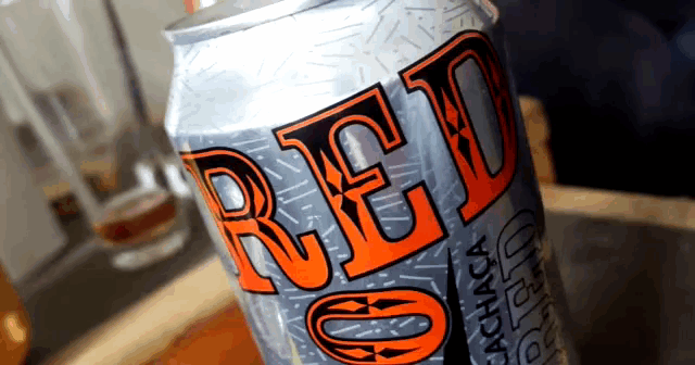 a can of red cachaca is on a table